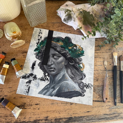 Artistic depiction of a face with nature elements on a wooden surface with art supplies.  By Kendelle Ashton.  Fine art print