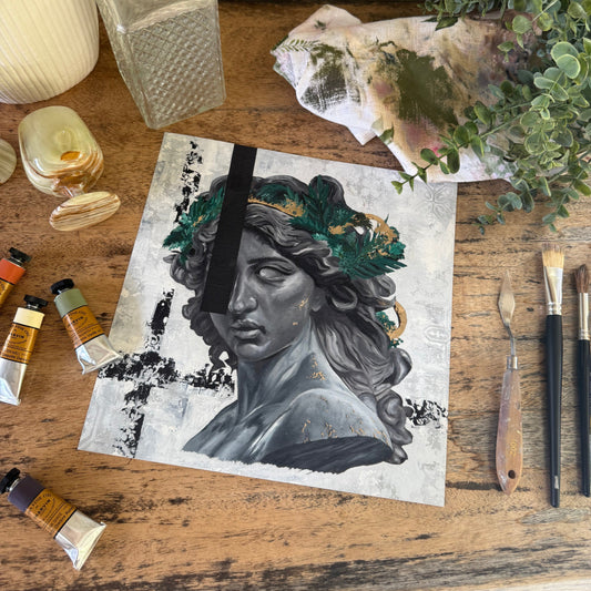 Artistic depiction of a face with nature elements on a wooden surface with art supplies.  By Kendelle Ashton.  Fine art print